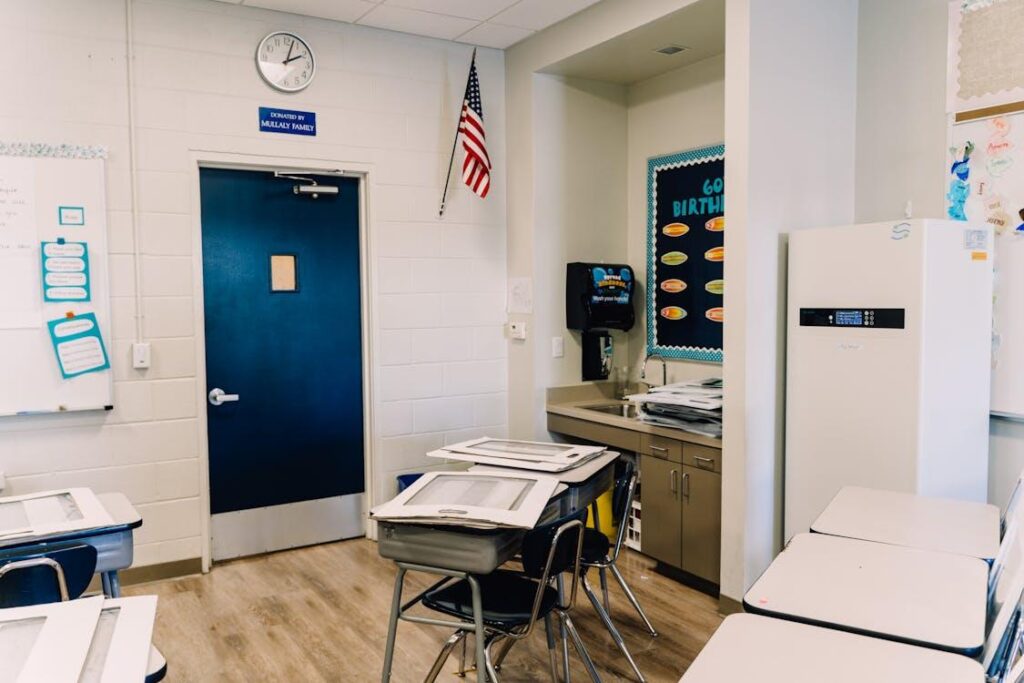 Clean classroom environment in a school with desks, sink area, and high-contact surfaces maintained through janitorial services.
