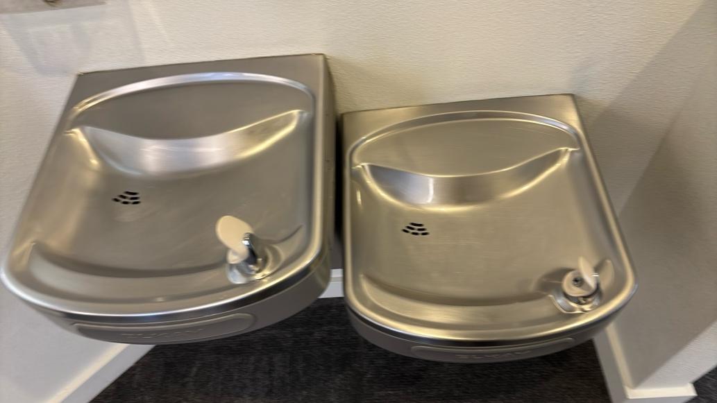 An image of two clean drinking fountains with push-button controls