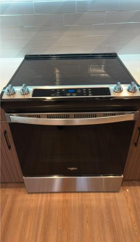 An image of a clean tiled kitchen backsplash with visible grout lines