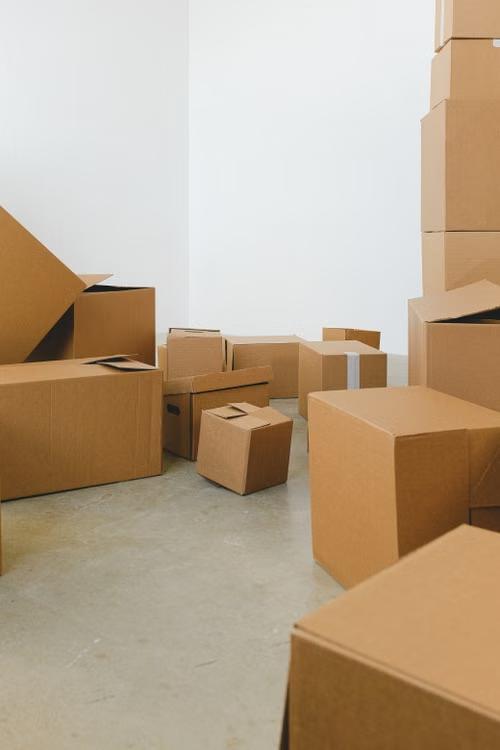 a pile of moving boxes placed on the floor
