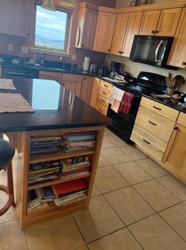 An image of a kitchen with a clean tile floor and visible grout lines